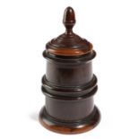 A TREEN LIGNUM VITAE TOBACCO JAR EARLY 19TH CENTURY the lid with an acorn finial, the body with