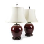 A PAIR OF CHINESE PORCELAIN SANG DE BOEUF VASE TABLE LAMPS LATE 19TH CENTURY with twin lights,