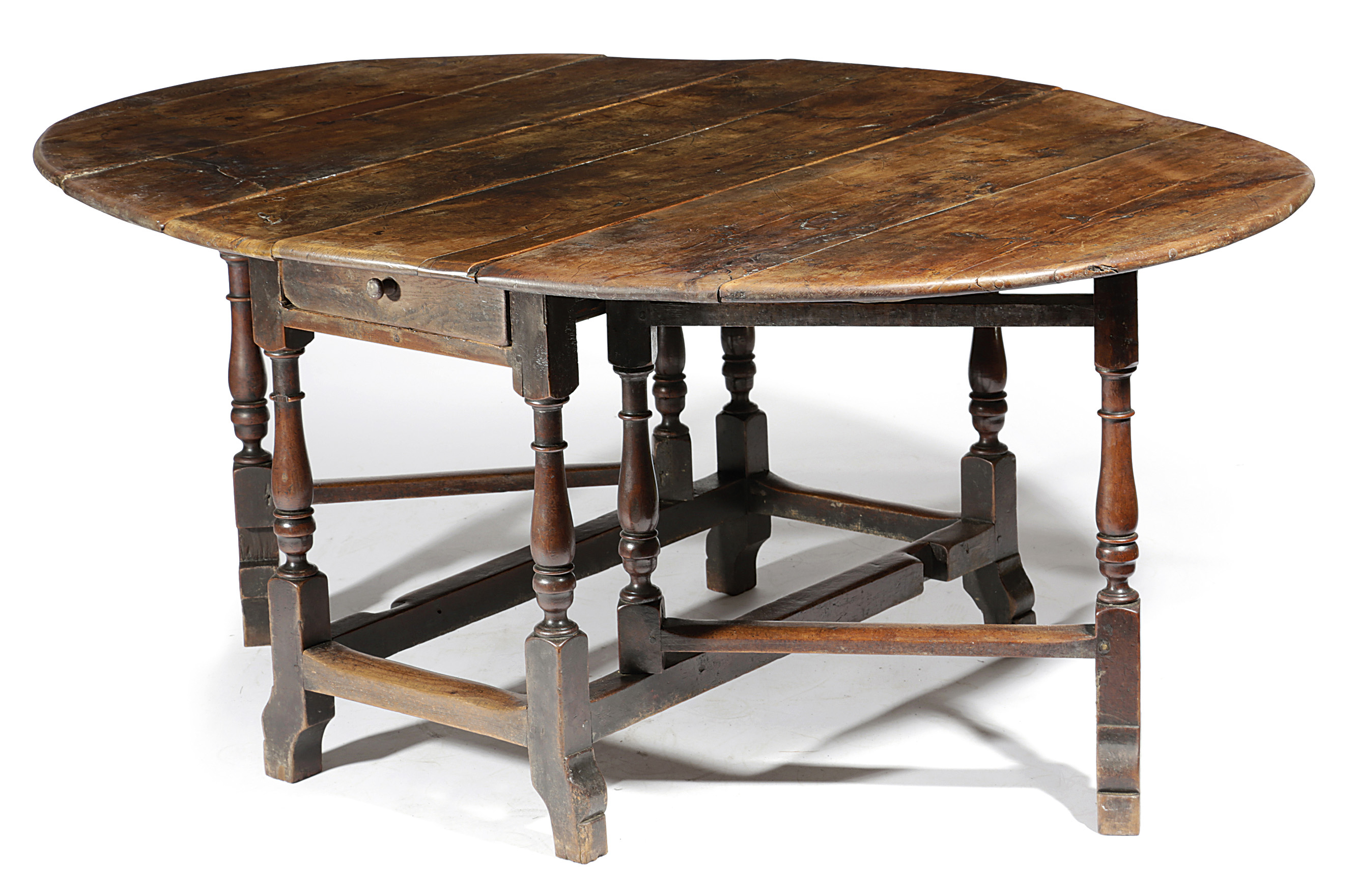 A WILLIAM AND MARY YEW GATELEG DINING TABLE LATE 17TH / EARLY 18TH CENTURY the oval drop-leaf top on
