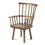 A WELSH PRIMITIVE WELSH ASH WINDSOR ARMCHAIR EARLY 19TH CENTURY with a stick back, above a burr