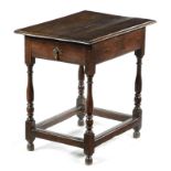 A QUEEN ANNE OAK OCCASIONAL TABLE EARLY 18TH CENTURY with a frieze drawer and on baluster supports