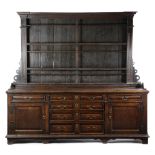 A LARGE EARLY GEORGE III OAK DRESSER C.1760-70 the architectural plate rack with fluted pilasters