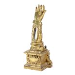 A SPANISH GILTWOOD RELIQUARY 18TH CENTURY in the form of an arm, inset with a mirror and on a scroll