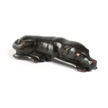 A SWEDISH TREEN DOG SNUFF BOX LATE 19TH CENTURY with an ebonised finish, the recumbent hound with