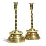 A PAIR OF FLEMISH BRASS CANDLESTICKS IN 15TH CENTURY STYLE each with a pierced socket, above a