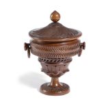 A TREEN FRUITWOOD URN AND COVER MID-19TH CENTURY with pierced and spiral fluted decoration and