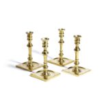 A SET OF FOUR BRASS CANDLESTICKS IN GEORGE III STYLE BY MAITLAND-SMITH, MID-20TH CENTURY each with a