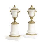 A PAIR OF FRENCH DIRECTOIRE MARBLE AND ORMOLU CANDLESTICKS C.1790 of urn form, each with a