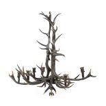 A TYROLEAN STYLE ANTLER CHANDELIER 20TH CENTURY with six lights 117cm high, 116cm wide Provenance