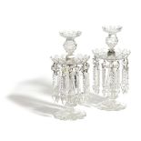 A PAIR OF EARLY VICTORIAN CUT-GLASS LUSTRE CANDLESTICKS C.1840 each with an urn shape sconce,