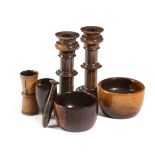 A SMALL COLLECTION OF TREEN LIGNUM VITAE ITEMS 19TH CENTURY comprising: a pair of candlesticks, a