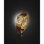 A gold 'Tank Basculante' wristwatch by Cartier, signed dial with secret signature at X, the plain