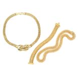 A fancy link gold necklace with conforming bracelet, and a choker-length gold necklace with lover'