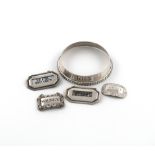 A collection of silver wine labels, comprising: a Victorian regimental wine collar, by Messrs. Lias,