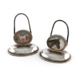 A pair of silver and painted porcelain menu card holders, retailed by Asprey and Co., London 1915,