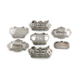A collection of seven silver wine labels, including a pair by Rawlings and Summers, London 1845,