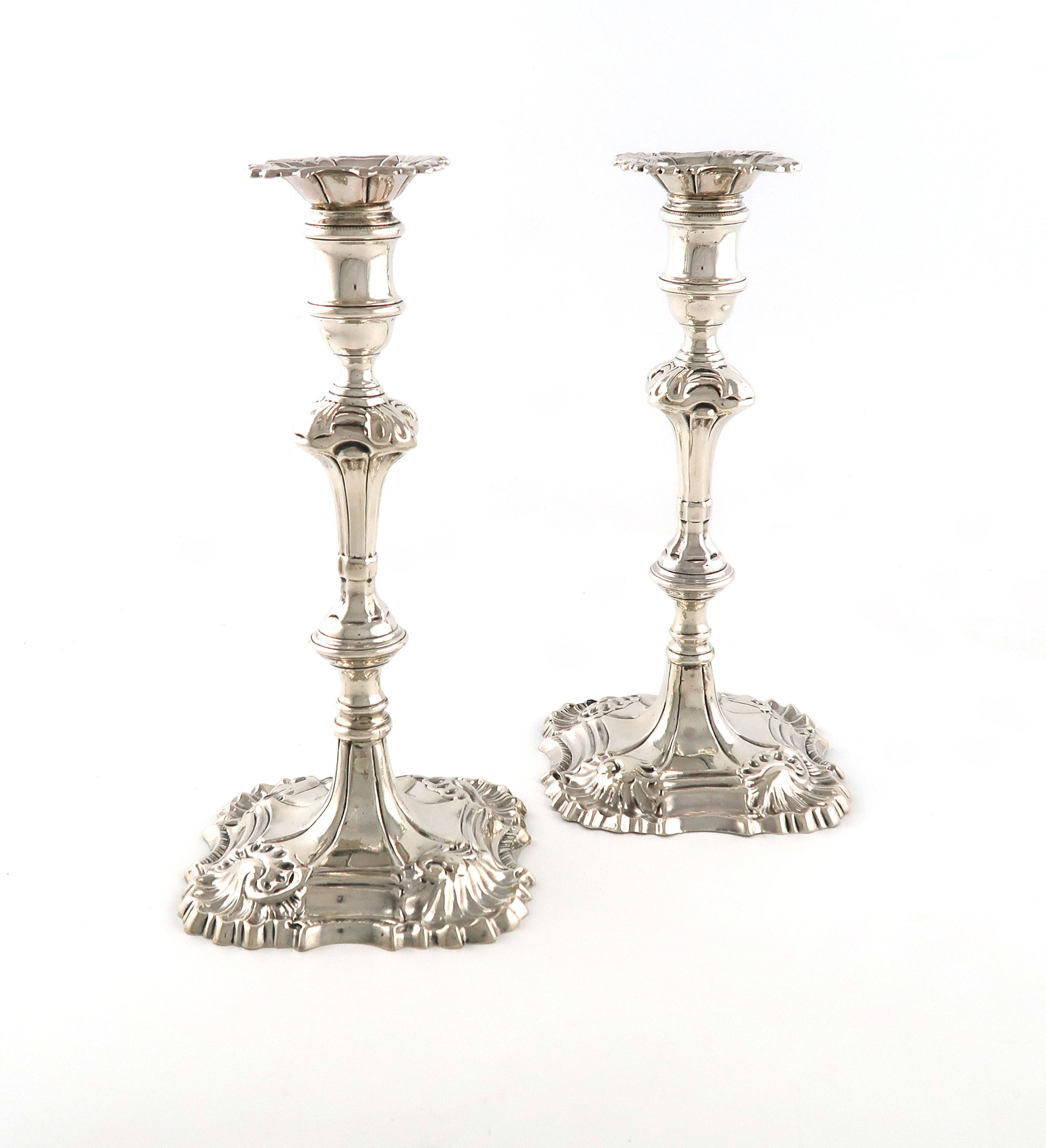 A pair of George II cast silver candlesticks, by William Cripps, London 1769, also with a French