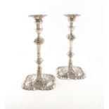 A pair of George II cast silver candlesticks, by William Cripps, London 1769, also with a French