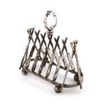 A novelty electroplated seven-bar toast rack, unmarked, the bars modelled as crossed cricket bats,