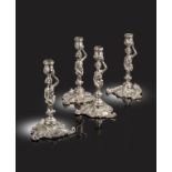 A matched set of four George II / George III cast silver candlesticks, two by John Cafe, London 1754