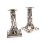 A pair of Edwardian silver candlesticks, by Thomas Bradbury, London 1901, the columns with bead