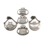 A collection of five George III silver raised pediment wine labels, comprising: two of crescent