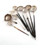 λA collection of nine silver punch ladles, comprising: a George II one, by William Justis, London