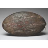 A Lake Sentani oval shallow dish Irian Jaya, Indonesia the underside carved a stylised four legged