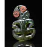 A Maori hei-tiki pendant New Zealand nephrite with red sealing wax eyes, 9cm high. Provenance