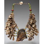 A Naga necklace Nagaland bovine teeth, bone, glass beads and shell, the central pendant with a