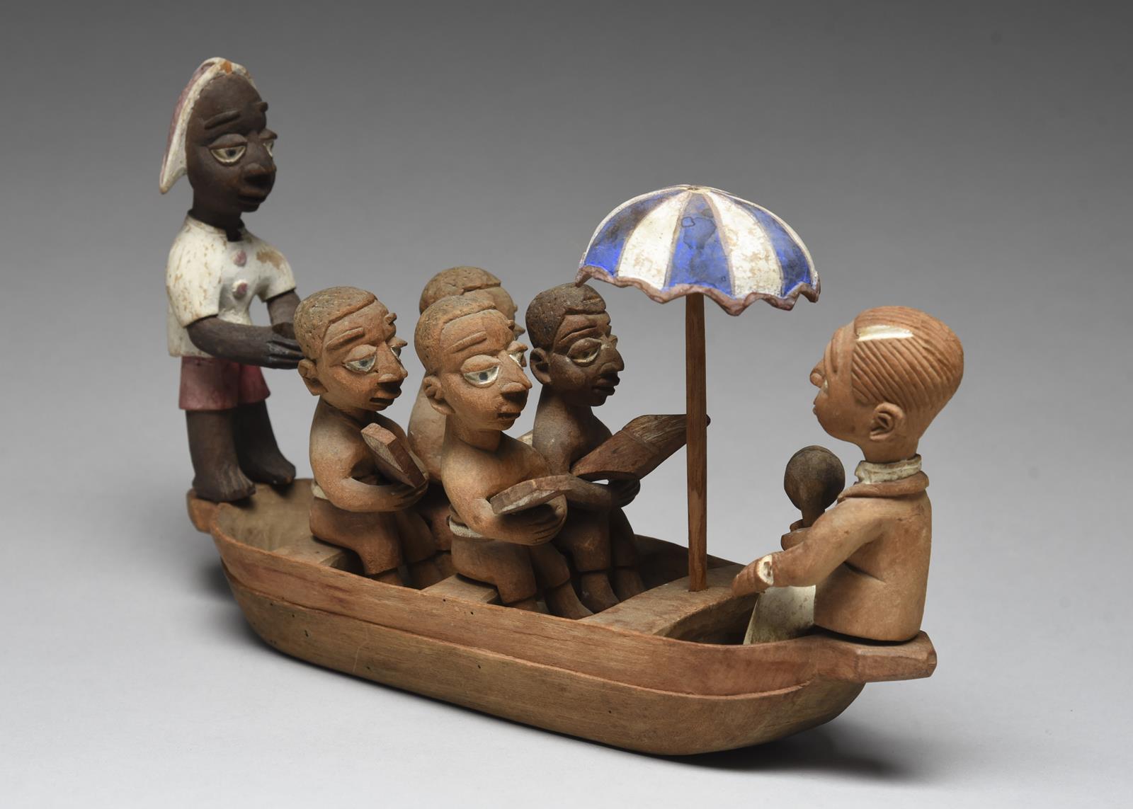 A Yoruba boat group by Thomas Ona Nigeria with a tiller man, four oarsmen with oars, an umbrella and - Image 3 of 4