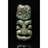 A Maori hei-tiki pendant New Zealand nephrite, one eye inset an haliotis shell scallop edge ring,