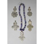 Five Ethiopian coptic cross pendants silver coloured metal, four hinged and one with glass trade