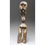 A Montol standing figure Nigeria with burn marks, 77.5cm high.