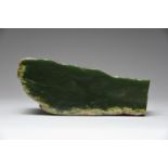 A Nephrite fragment New Zealand one side polished and one with a groove, 14.5cm long.