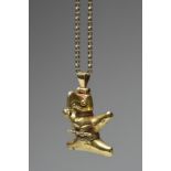 A Tairona style gold eagle pendant perched on a branch with a splayed tail and extended wings, 4cm