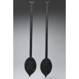 Two Benin paddles with leaf shape blades and long handles, both with all-over carving, one carved an