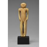 λAn Inuit standing figure Arctic walrus ivory, with hands resting on the hips and remains of line