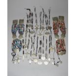 Twenty one Tuareg amulet necklaces silver coloured metal of differing forms with incised