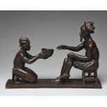 A Kinshasa carved group of two figures of a male seated on a stool, with a finely engraved multi-