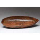 A Hawaii bowl Polynesia kou wood, with a flat end and a pointed end, 55cm long, 9.5cm high.