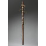 An African measuring implement the wood pole with a tapered end and pierced at the other for