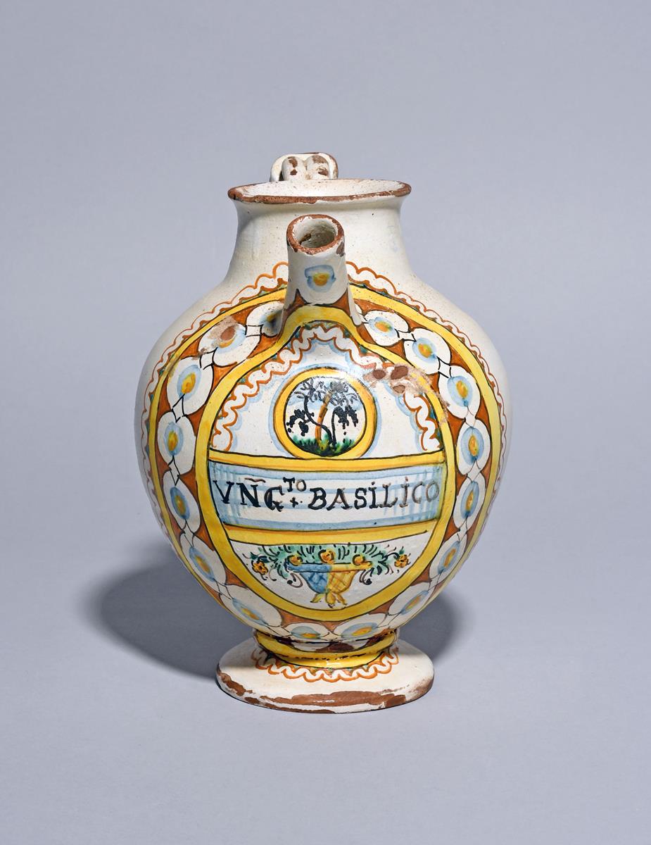 An Italian maiolica syrup or wet drug jar, c.1700, the ovoid body titled 'UNG to BASILICO' in