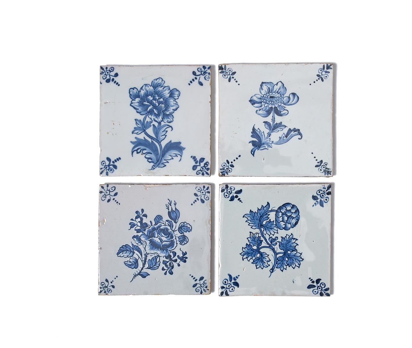 Four Lambeth delftware botanical tiles, c.1760-80, finely painted in blue, each with a single flower