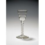 A Lynn wine glass, c.1760, the rounded funnel bowl moulded with three horizontal ribs, raised on a