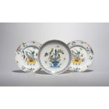 A pair of London delftware plates, c.1760, painted in polychrome enamels with birds perched on reeds