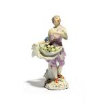 A Meissen figure of a lemon seller, mid 18th century, modelled by F E Meyer, standing and holding