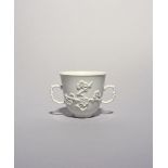 A good Bow white-glazed two-handled cup, c.1754-55, the U-shaped form crisply moulded with two