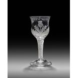 A rare Jacobite wine glass or goblet, c.1750-60, the tulip bowl engraved with an upright thistle