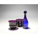 A pair of amethyst glass fingerbowls, early 19th century, with ridged bands around the centre, and a
